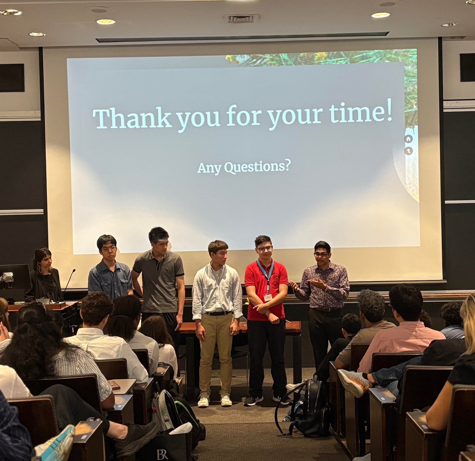 Presenting disaster relief research on stage at Columbia University with team